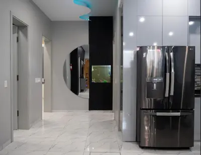 a large refrigerator in a room with a mirror at Top-Level Pool in Praia