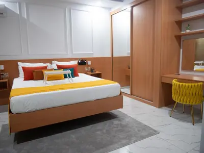 a bedroom with a bed with a desk and a chair at Top-Level Pool in Praia