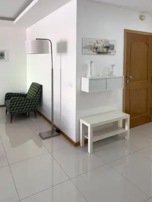 a room with a chair and a table and a lamp at Spacious 3-bdr apt seafront, exterior pool - LCGR in Praia