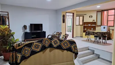 a living room with a couch and a dining room at Kaza Manata in Praia