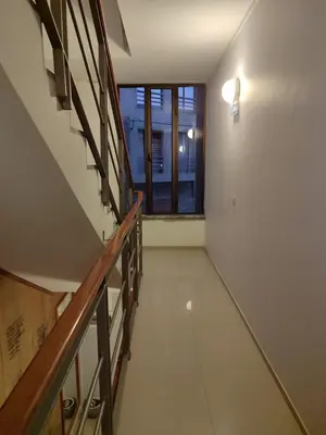 an empty hallway with a staircase and a window at Residencial P&P in Mindelo