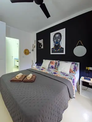 a bedroom with a large bed with two towels on it at Casa Albacora in Sal Rei