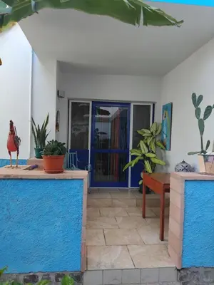 a patio with a table and potted plants at Moradias No Stress in Santa Maria