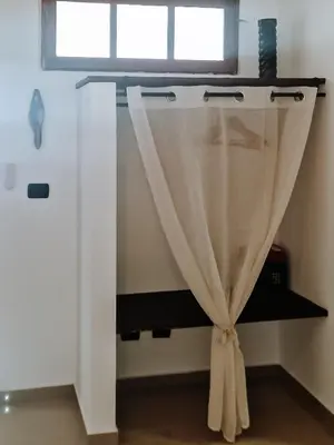 a curtain in a room with a window at Casa Cesaria Guest House in Sal Rei