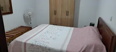 a bedroom with a bed and a fan at Casa Flor Apartment in Ribeira Grande