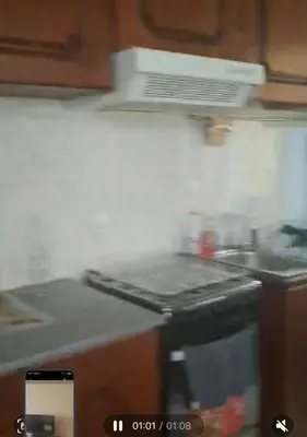 a kitchen with a stove with smoke coming out of it at kaza sz in Praia