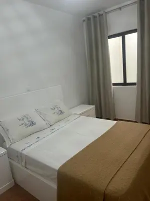 a bedroom with a large bed with a window at Morabeza Lodge in Mindelo