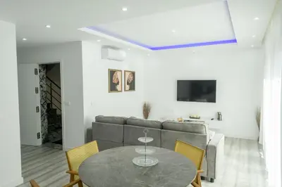 a living room with a table and a couch at Edifício Yes, Luxury 2 Bed Apartments, Praia, Cape Verde with Balcony and AC in Praia