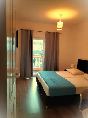 a bedroom with a bed and a large window at Hotel Miranda & Miranda in Ponta do Sol