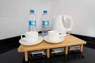 a coffee table with cups and bottles of water at GREEN STUDIO TARRAFAL - Ap 02 in Prainha
