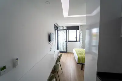 a white room with a bed and a window at GREEN STUDIO TARRAFAL - Ap 01 in Prainha