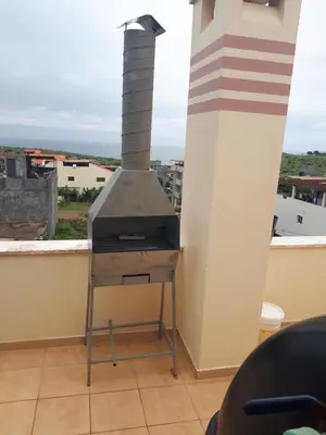a stove on a balcony with a view of a city at Avenida NHU SANTIAGO in Santa Cruz