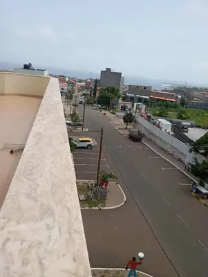 a person riding a skateboard down a city street at Avenida NHU SANTIAGO in Santa Cruz