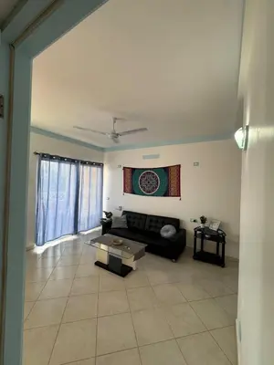 a living room with a couch and a table at Holiday Properties Ocean Breeze in Santa Maria