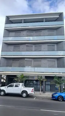 a white truck parked in front of a building at Clara's Place - Faia Suite in Praia