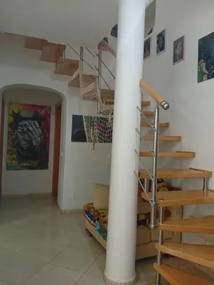 a room with a spiral staircase in a house at Four Palms Guest House in Praia