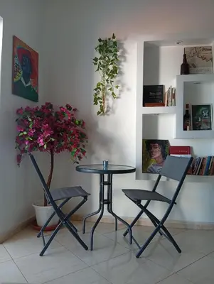 a table and two chairs and a table with a plant at Four Palms Guest House in Praia