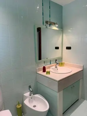 a bathroom with a sink and a toilet and a mirror at Murdeira Villa with Private Pool V164 by RPG Group in Beirona