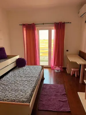 a bedroom with a bed and a window with pink curtains at Murdeira Villa with Private Pool V164 by RPG Group in Beirona