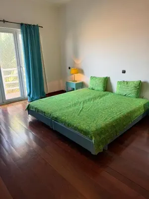 a bedroom with a bed with a green comforter at Murdeira Villa with Private Pool V164 by RPG Group in Beirona