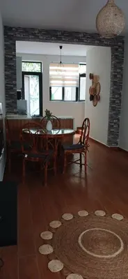 a living room with a dining room table and chairs at Cozy Apartment in Praia