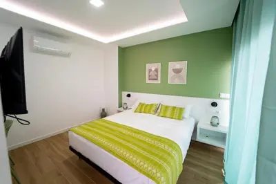 a bedroom with a bed with yellow and green walls at GREEN STUDIO TARRAFAL - Ap 04 in Tarrafal