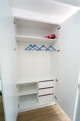 a white closet with white shelves and drawers at GREEN STUDIO TARRAFAL - Ap 04 in Tarrafal