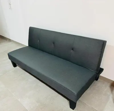 a black couch sitting in a room at Estúdio com vista Praça do Presidente in Santa Maria