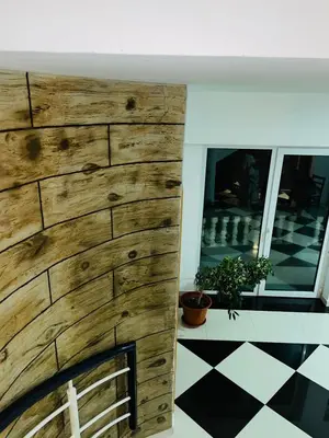 a fireplace in a room with a wooden wall at Residencial Sol Point Art in Ponta do Sol