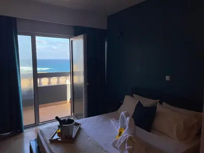 a bedroom with a bed with a view of the ocean at Residencial Sol Point Art in Ponta do Sol