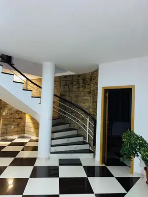 a staircase with a black and white checkered floor at Residencial Sol Point Art in Ponta do Sol