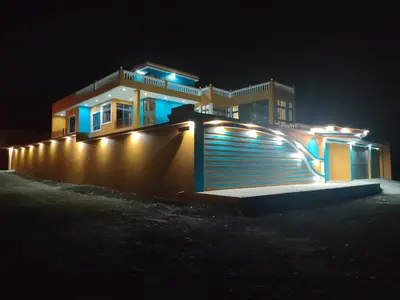 a building with lights on the side of it at night at Residencial oliveira in Porto Novo