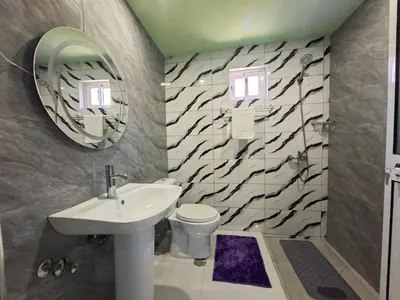 a bathroom with a sink and a toilet and a mirror at Funco Du Santos in Portela