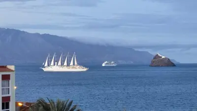 two boats in the water with a mountain in the background at Ocean View Studio 4 in Mindelo