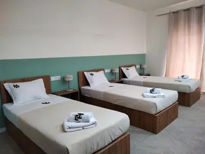 a room with two beds with towels on them at Urban Hostel Mindelo in Mindelo