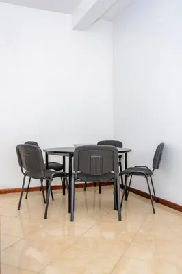 a black table and four chairs in a room at Mindelo Dias in Mindelo