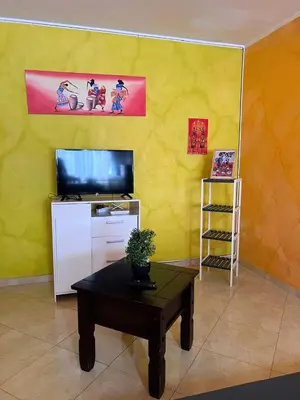 a living room with a tv and a coffee table at Tropical Breeze Holidays in Santa Maria