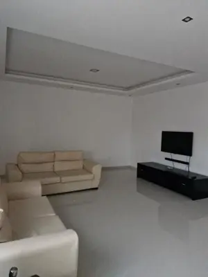 a living room with a couch and a television at Gaudencio Fernandes in Praia