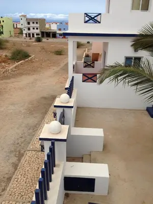 a group of benches sitting on the side of a house at Maio Relax in Vila do Maio