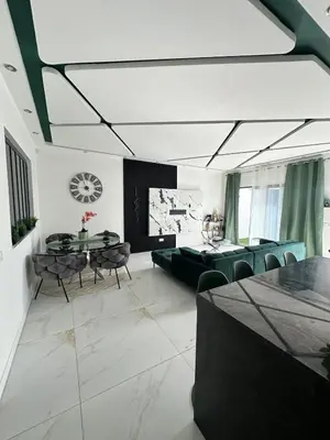 a living room with a table and chairs at Belle maison Cosy et Moderne in Praia