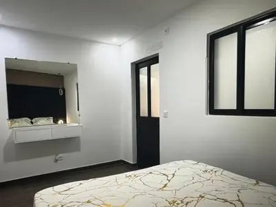 a white room with a bed and a mirror at Tropical Nest in Espargos