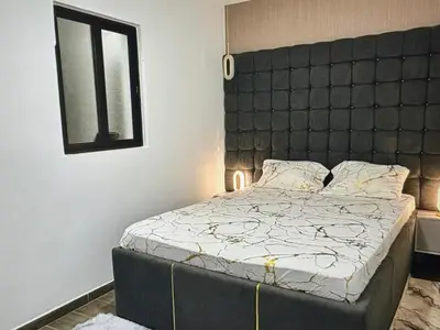 a bedroom with a large bed with a black headboard at Tropical Nest in Espargos