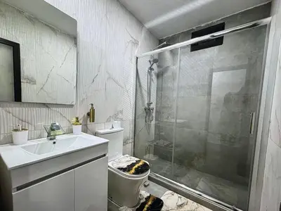 a bathroom with a shower and a toilet and a sink at Tropical Nest in Espargos