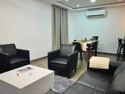 a living room with a couch and chairs and a table at Tropical Nest in Espargos