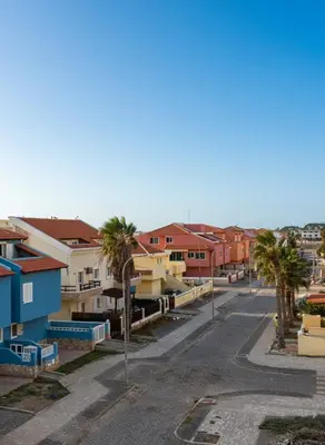 an empty street with palm trees and buildings at Seafront Apartment Shell Beach & Kite Beach Views in Santa Maria