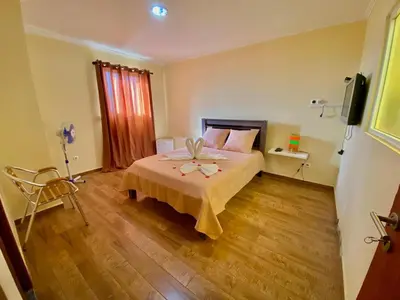 a bedroom with a bed and a television in it at Pensão Twins Carioca in Tarrafal