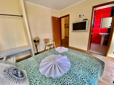 a room with a bed with an umbrella on it at Pensão Twins Carioca in Tarrafal