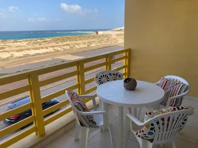 a table and chairs with a view of the beach at My Boavista 3 in Sal Rei