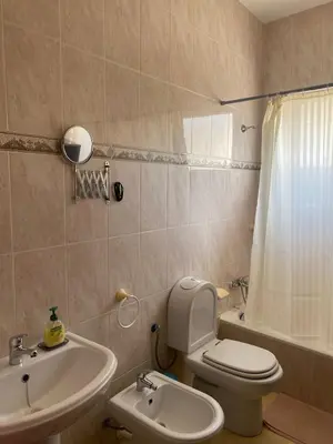 a bathroom with a white toilet and a sink at Mindelo Family Apartment in Mindelo