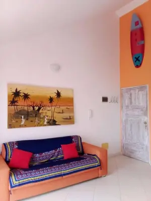 a couch in a room with a painting on the wall at Holiday Properties Vista Do Mar - Wi-fi in Santa Maria